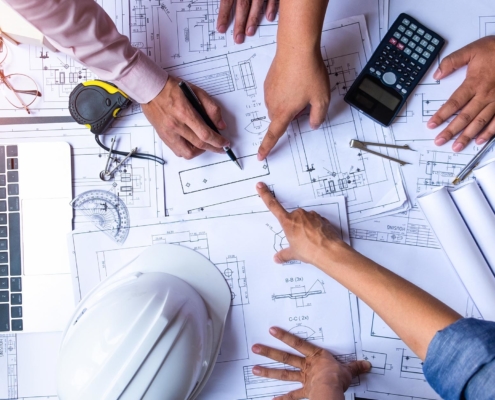 Image of engineers drawing blueprints for a construction project